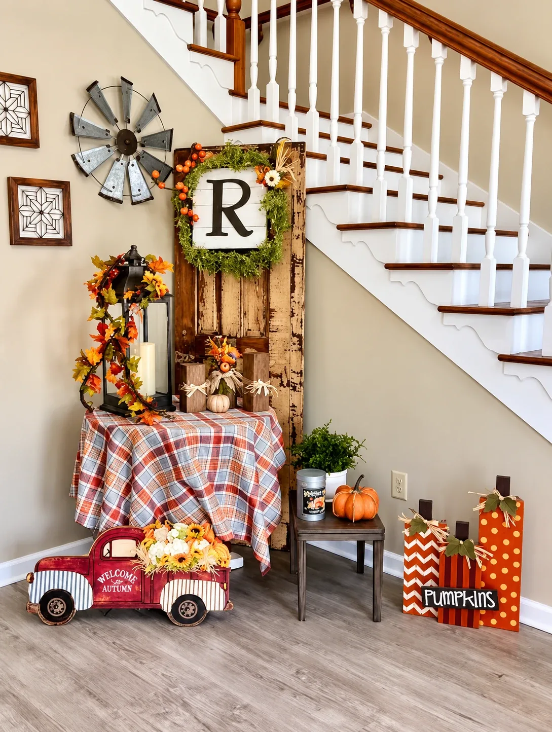 The front entry of Regency House, with the monogram wreath, lantern and seasonal decorations beneath the staircase
