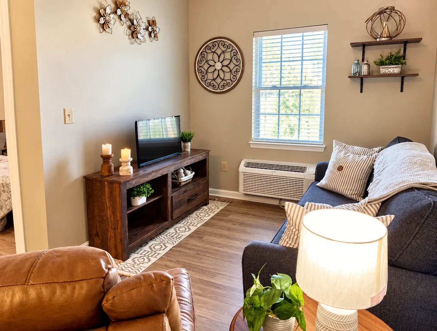 A furnished Regency House apartment with a sofa, television and a view to the bedroom